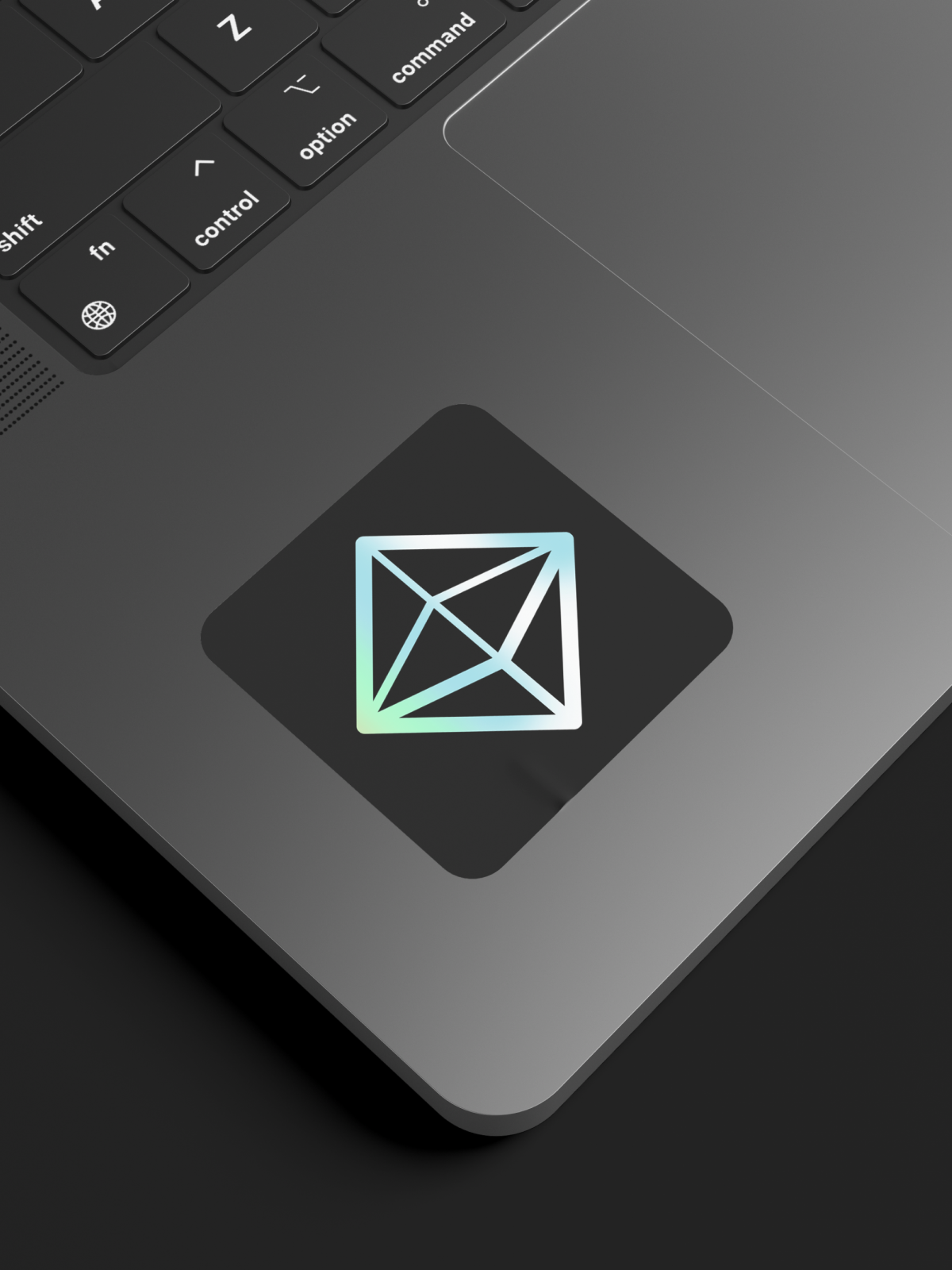 Holographic octahedron sticker on a laptop